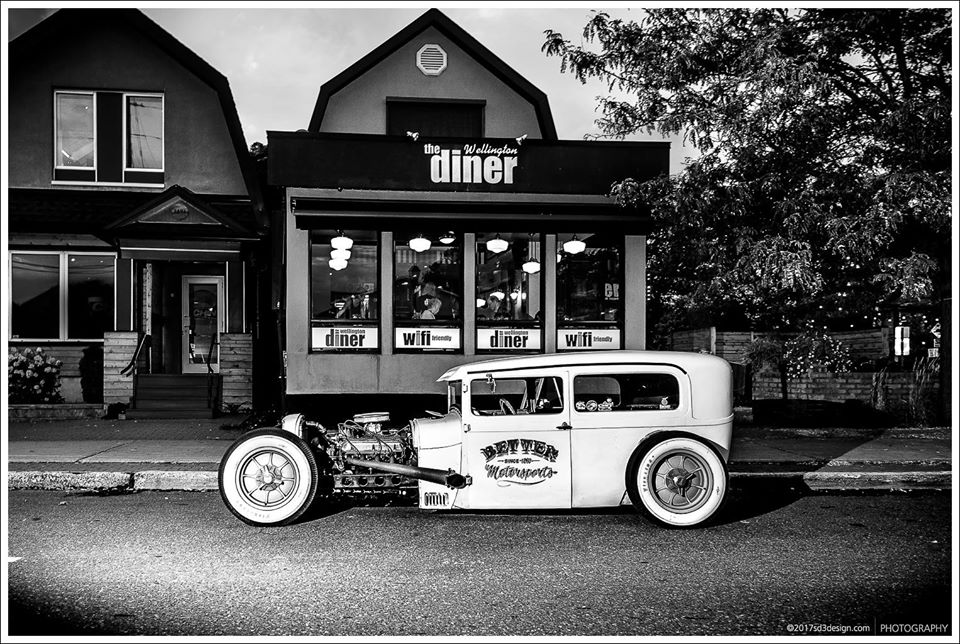 The Wellington Diner storefront on Wellington Street West, with a hot rod parked out front.